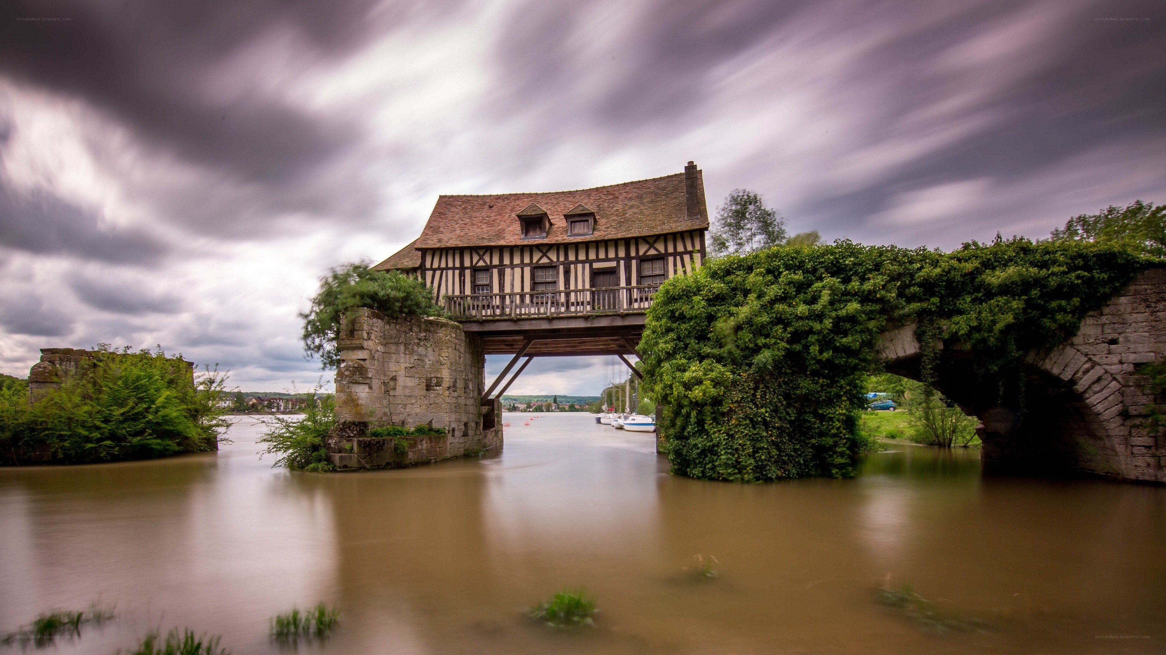Historic bridge with house over river
