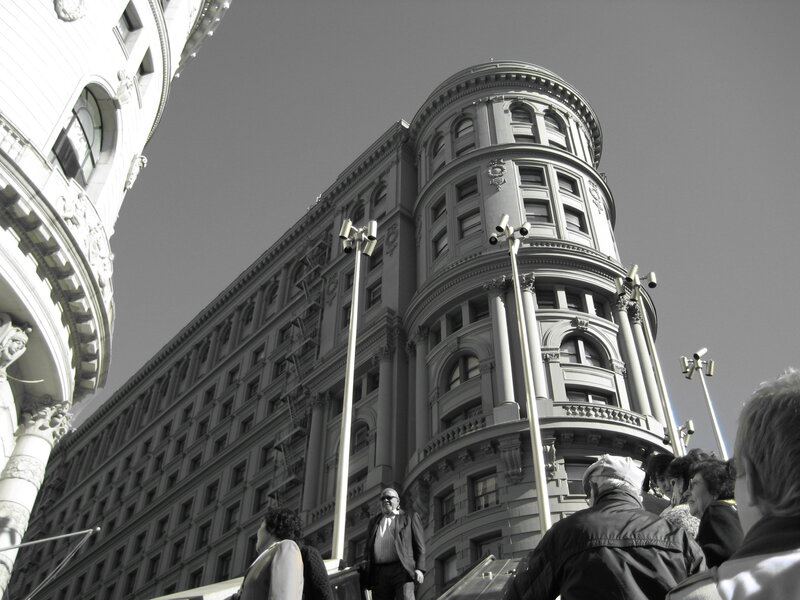 Historic building corner with people