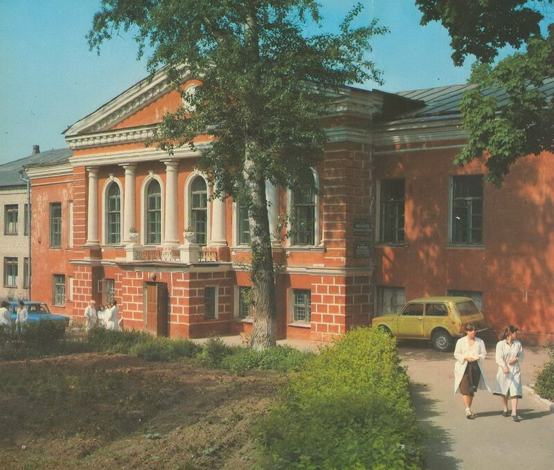 Historic building with people and cars