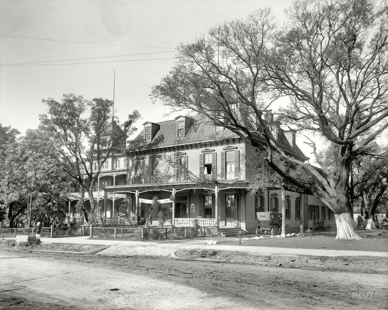 Historic building with porch and trees