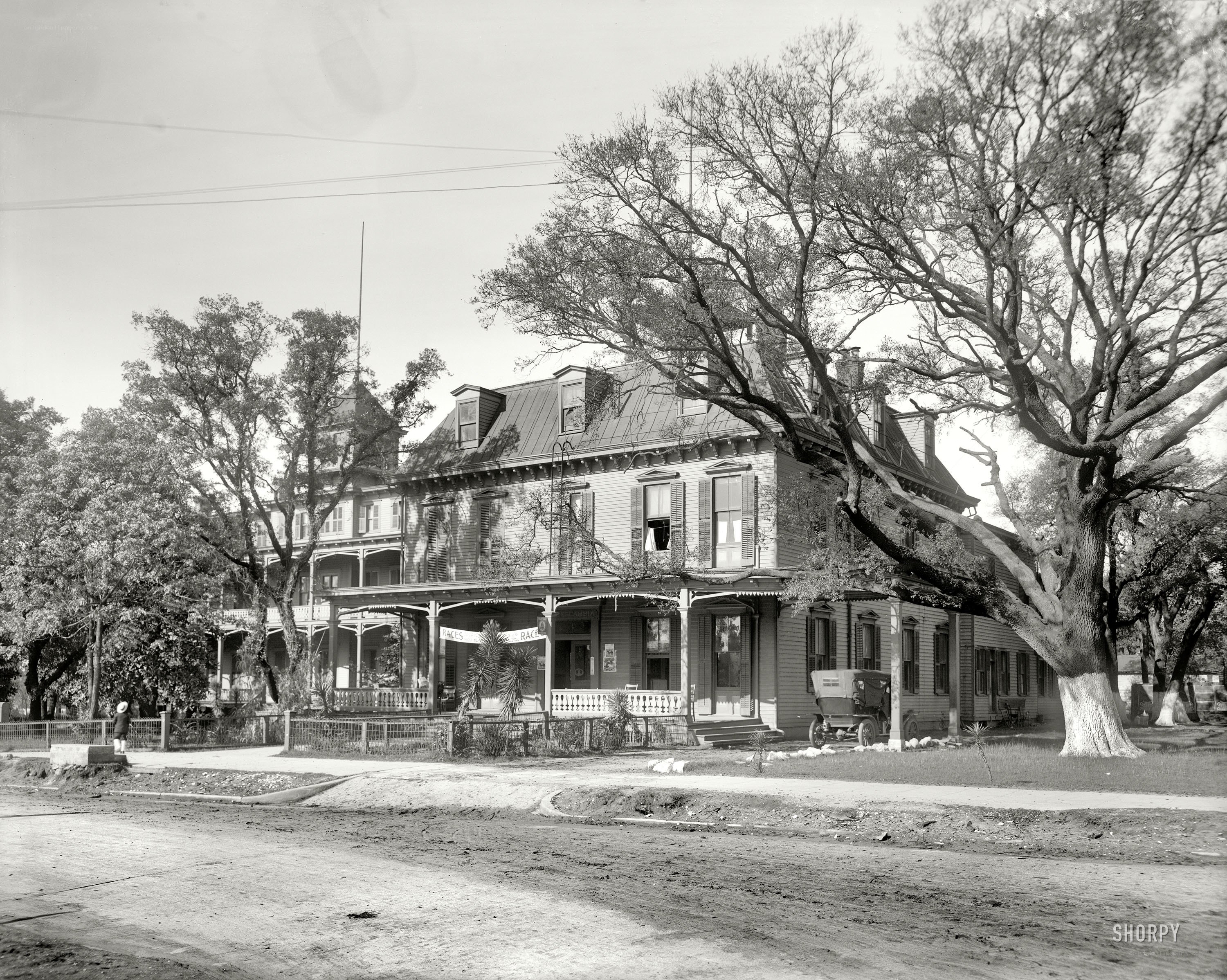 Historic building with porch and trees