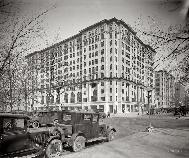 Historic building with vintage cars
