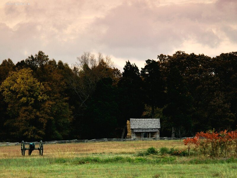 Historic cabin in autumn field