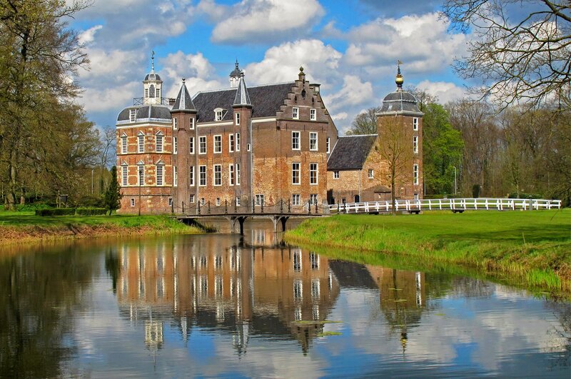 Historic castle with moat reflection