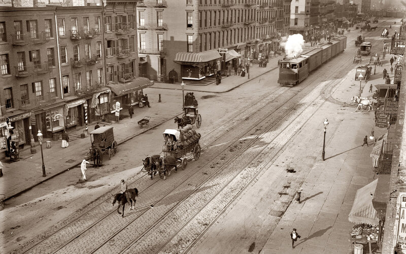 Historic city street with steam train