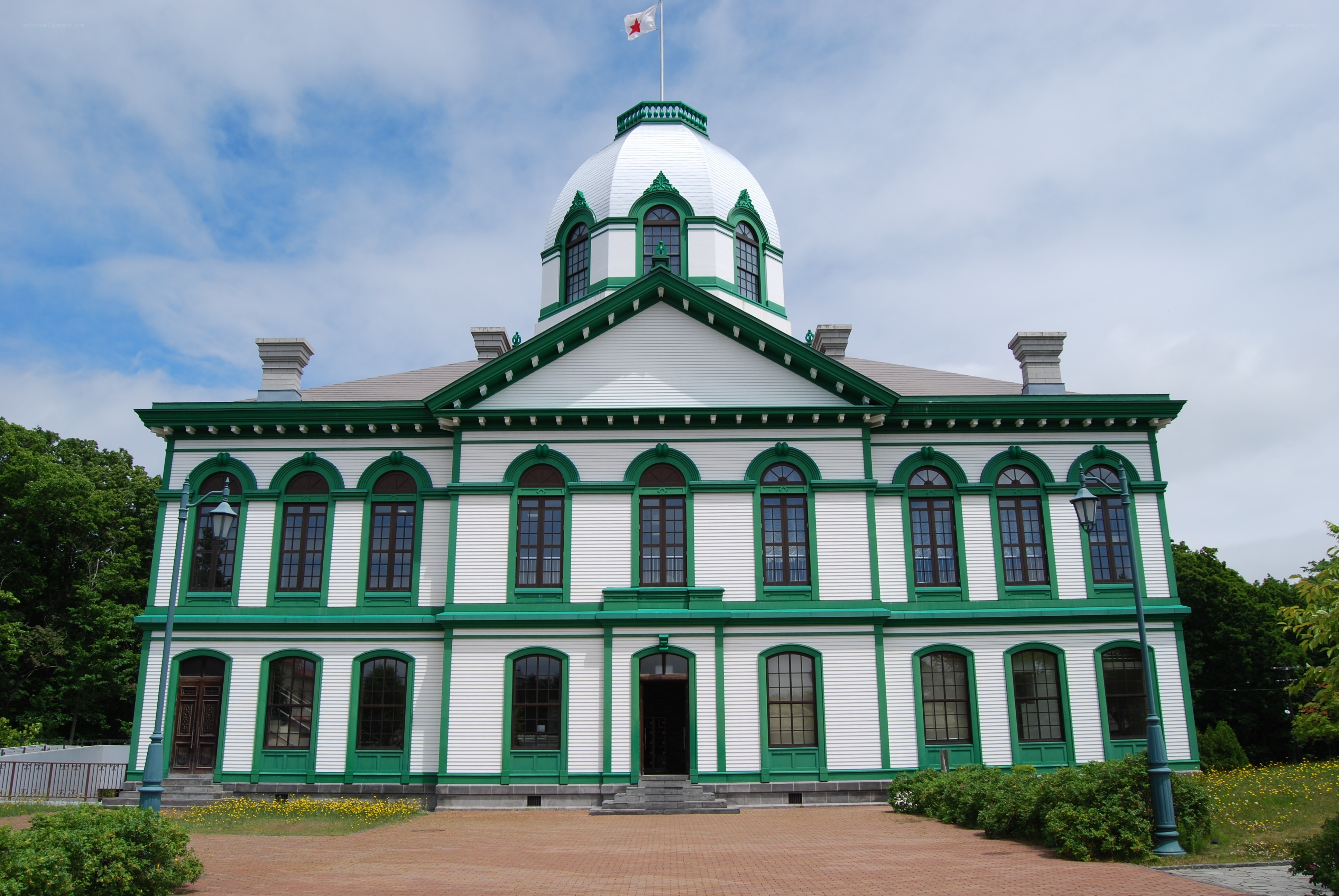 historic green and white building