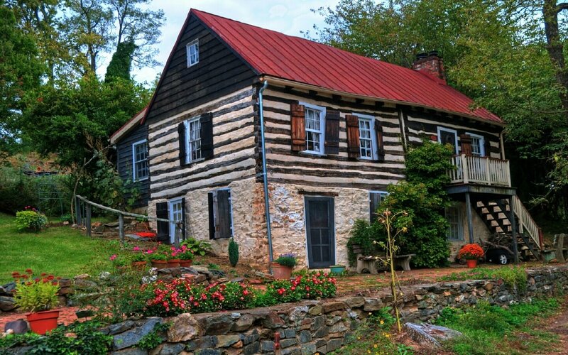 historic log cabin with red roof