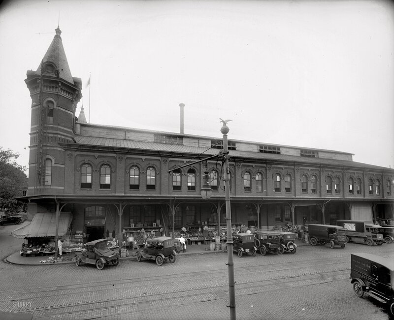 Historic market building with vintage cars
