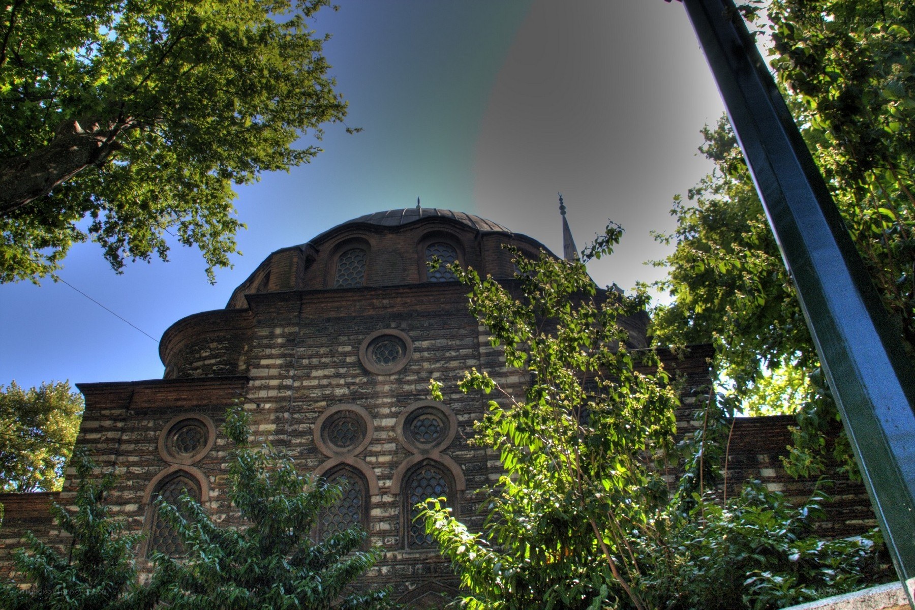 Historic mosque with dome and trees