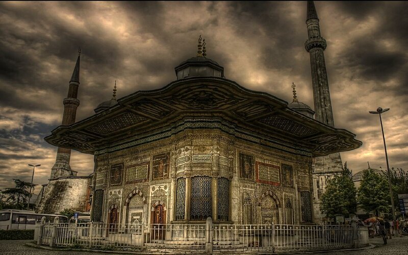 Historic Ottoman fountain under stormy sky