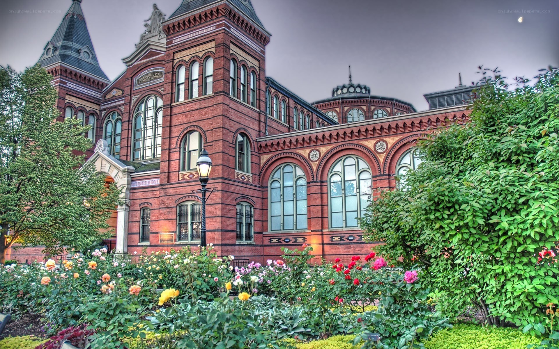 Historic red brick building with garden