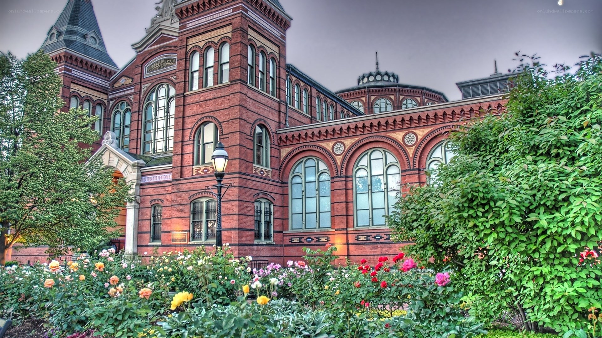 Historic red brick building with garden