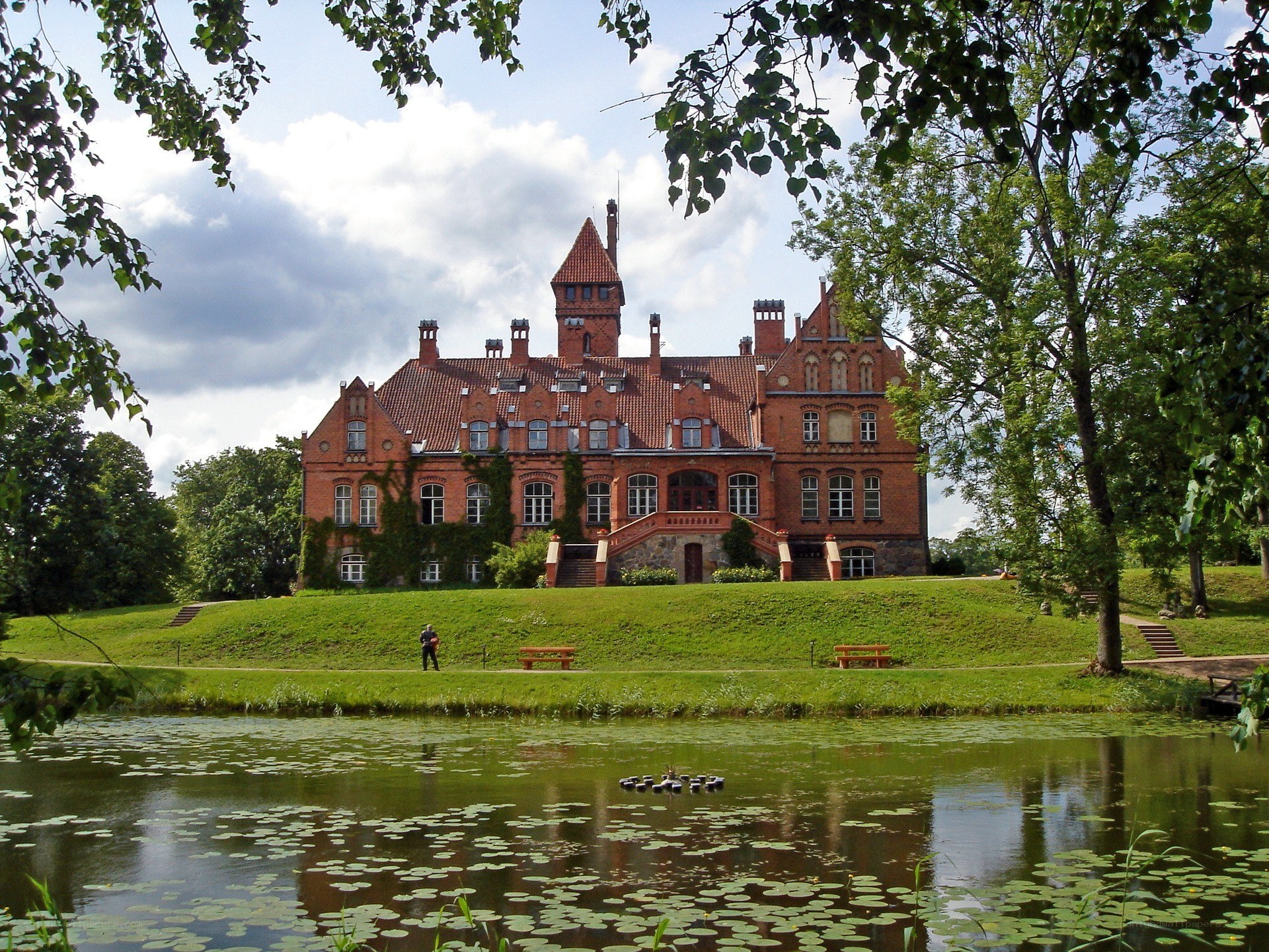 Historic red-brick castle by a pond