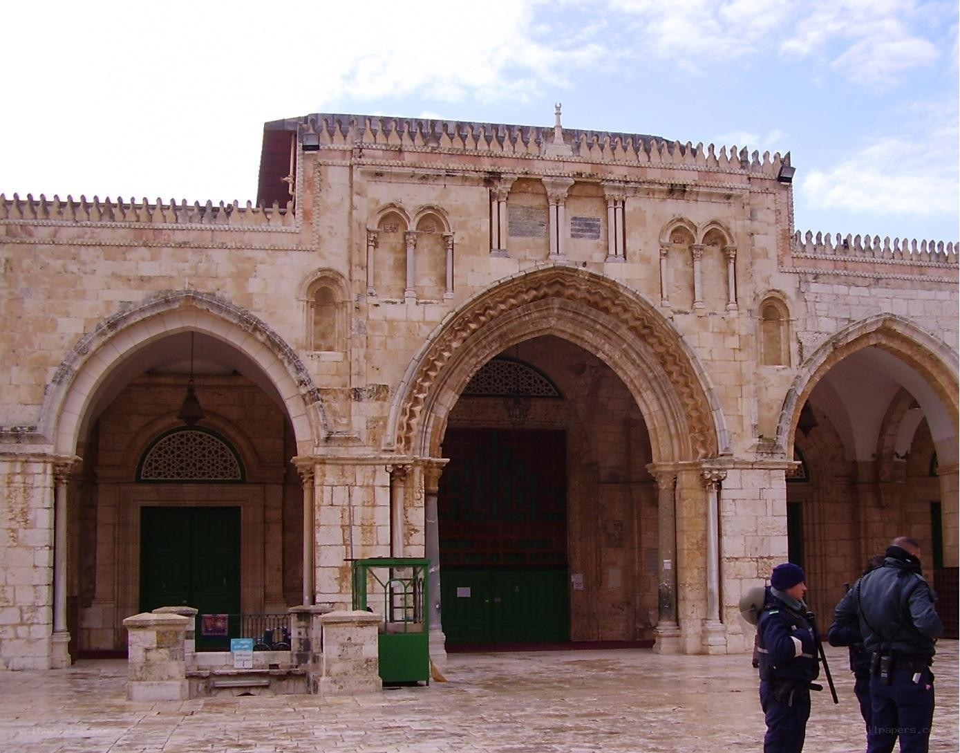 Historic stone archway with guards