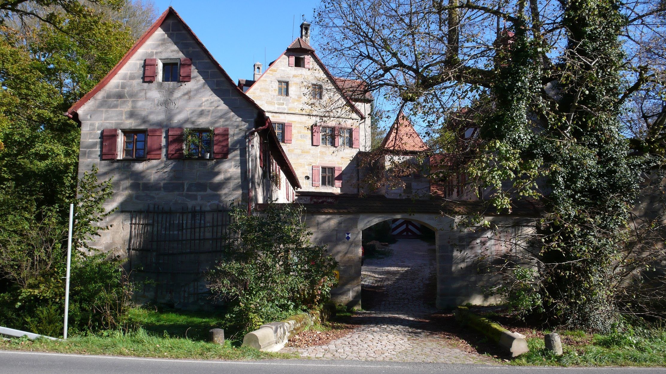 historic stone building with arched gateway