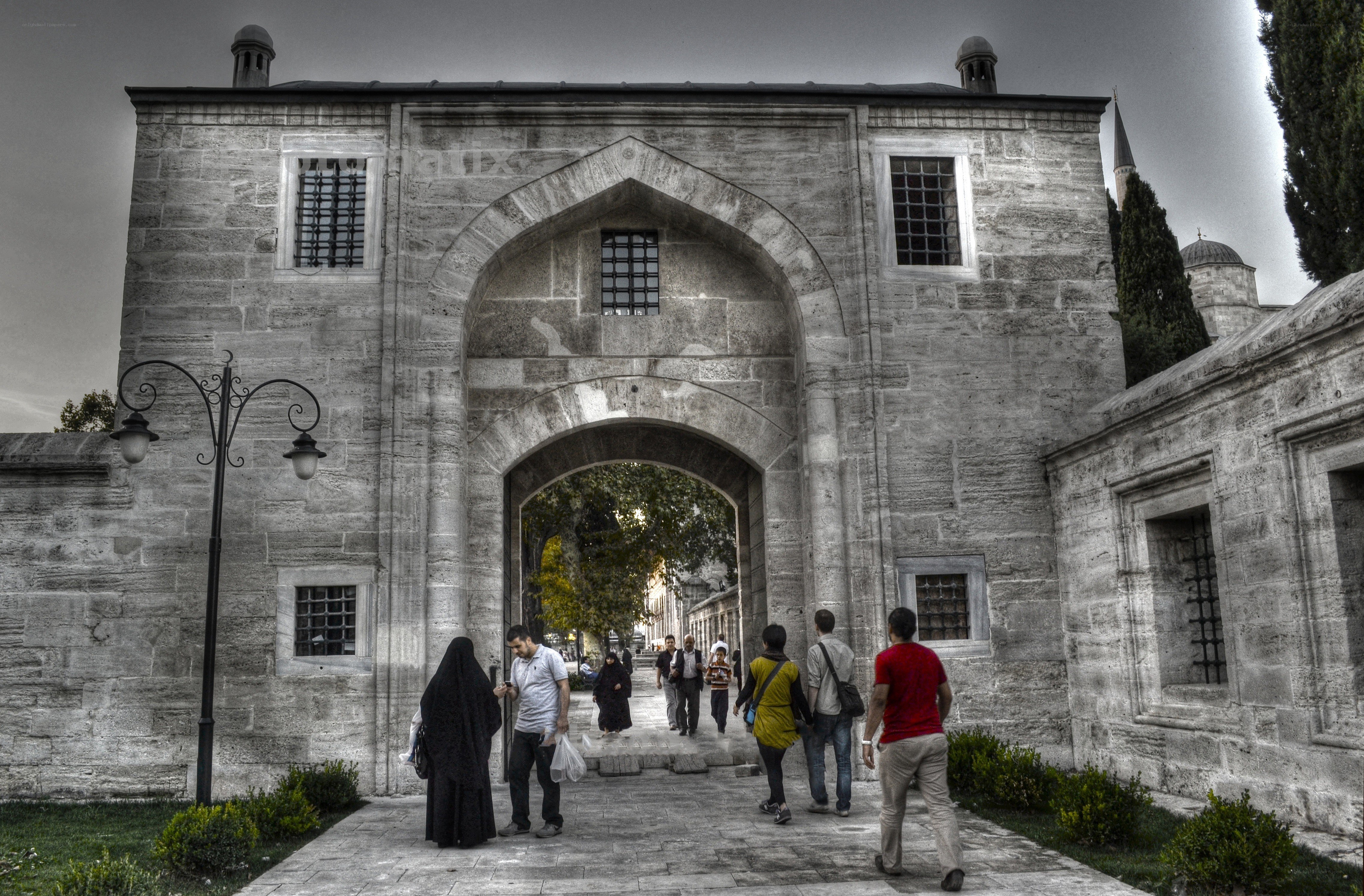 Historic stone gateway with visitors