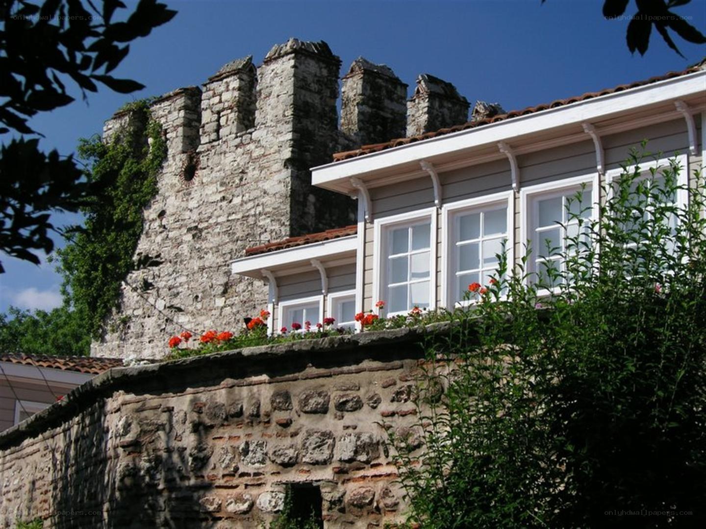 Historic stone wall with modern house