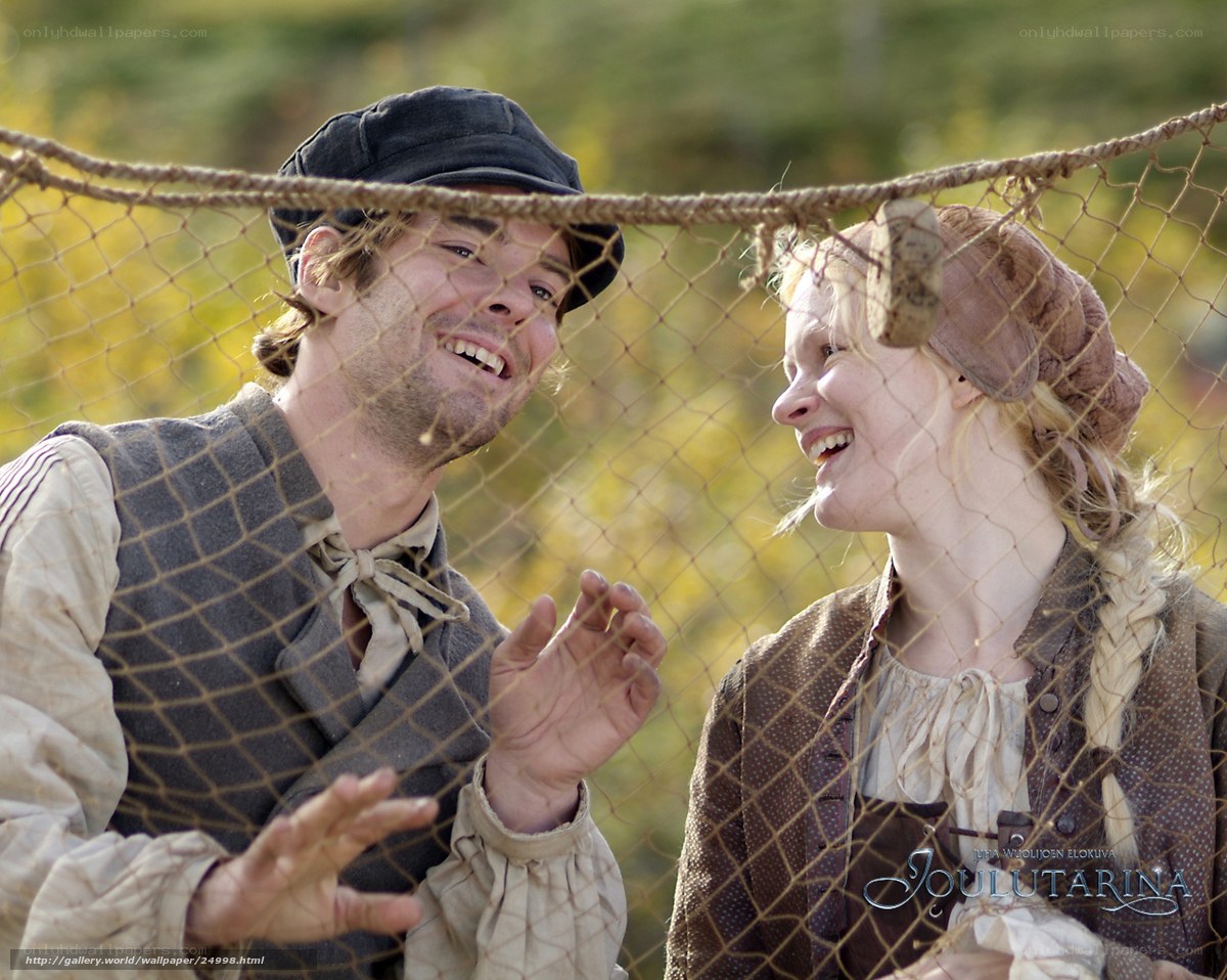 Historical couple laughing behind net