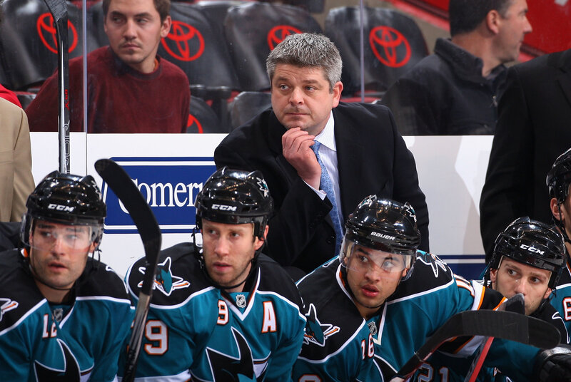 Hockey coach with players