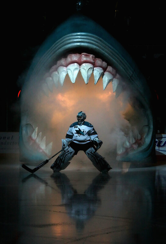 Hockey goalie in front of shark sculpture