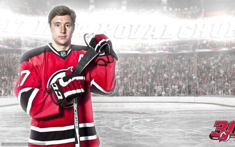 Hockey Player Holding Stick — Red