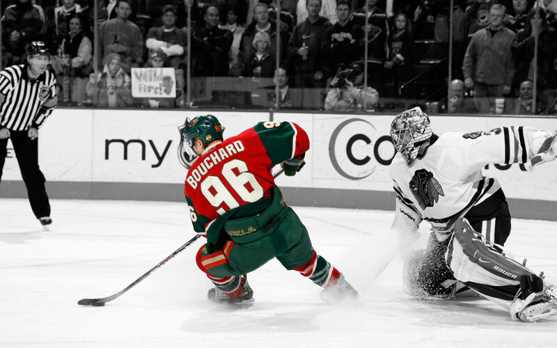 Hockey player shooting on goalie