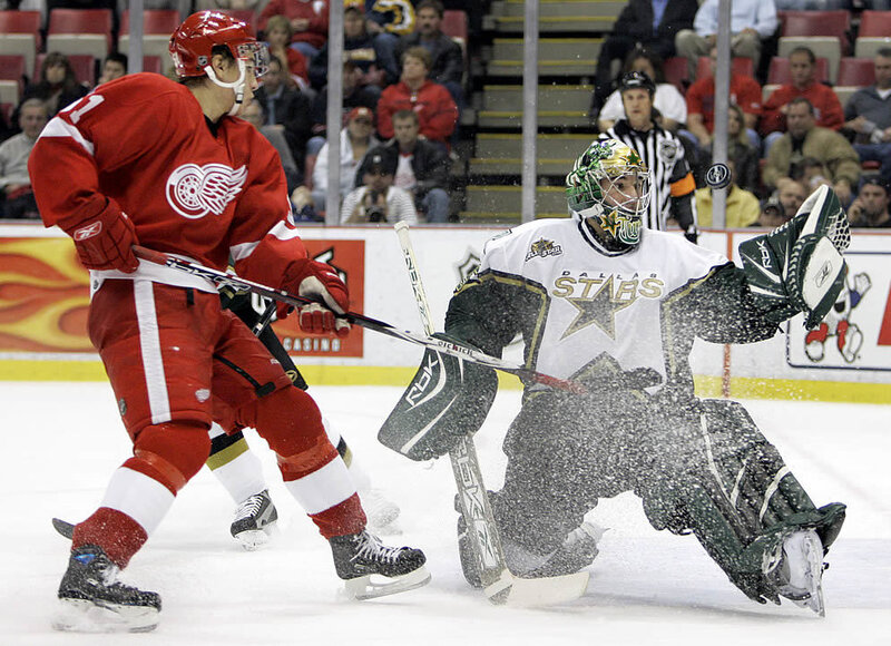 Hockey player shooting on goalie