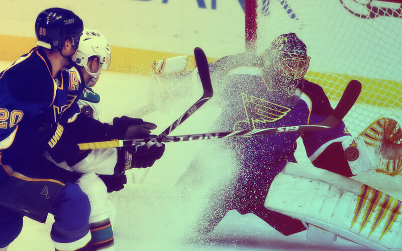 Hockey player shoots on goalie