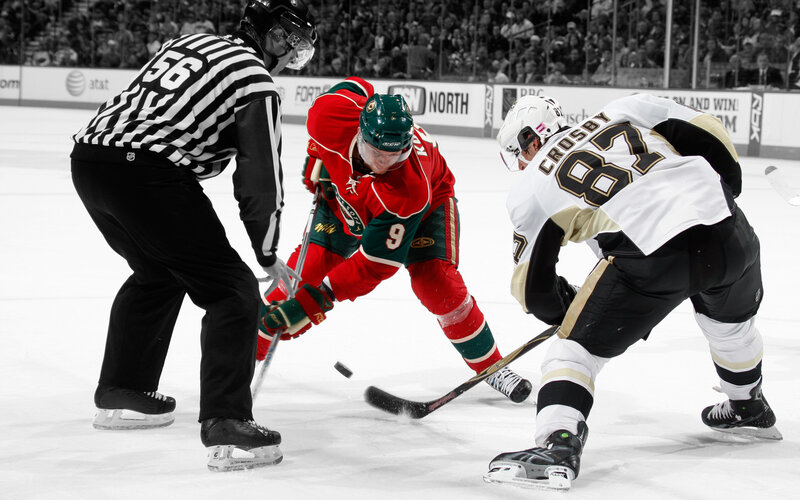Hockey players battling for puck