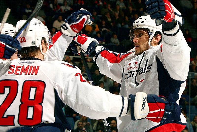 Hockey players celebrating a goal