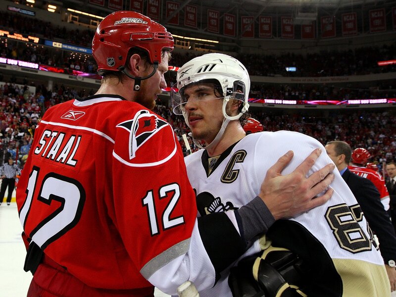Hockey players embrace after game