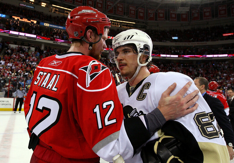 Hockey players embrace after game