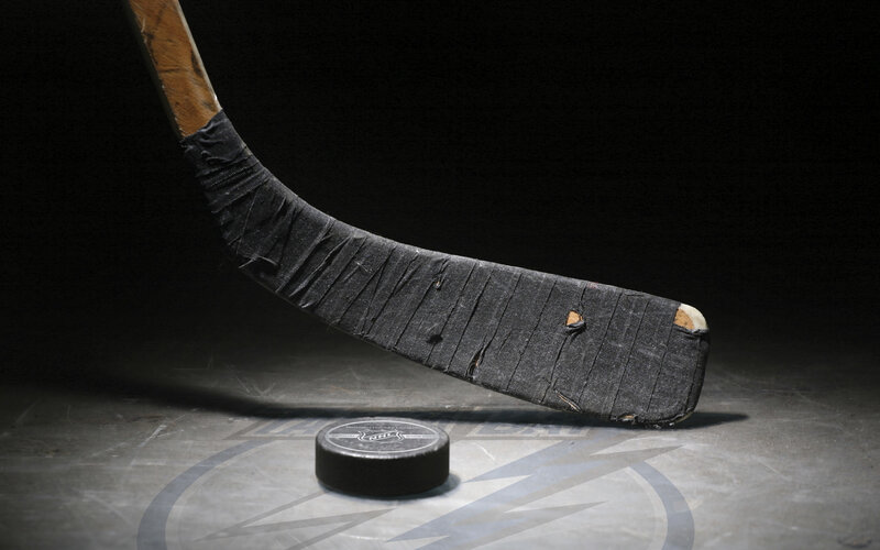 Hockey stick and puck on ice