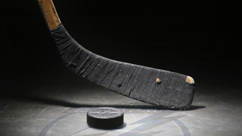 Hockey stick and puck on ice