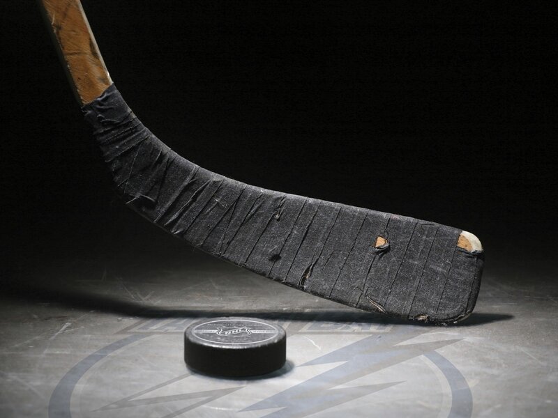 Hockey stick and puck on ice