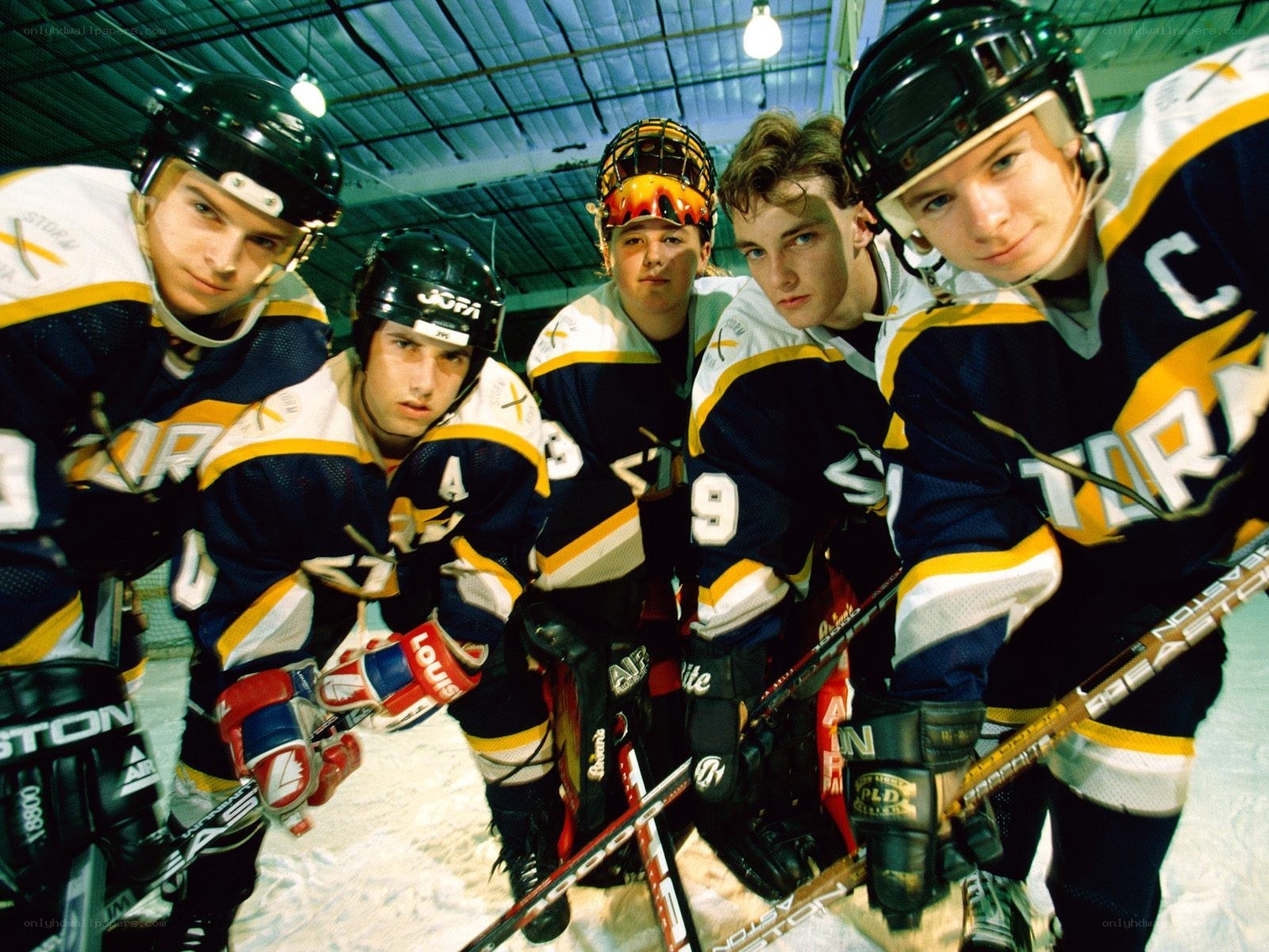 Hockey team posing on ice