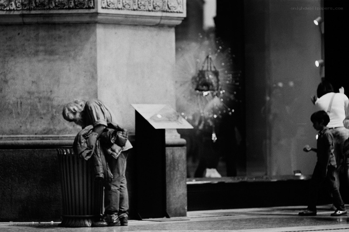 Homeless person at a trash can