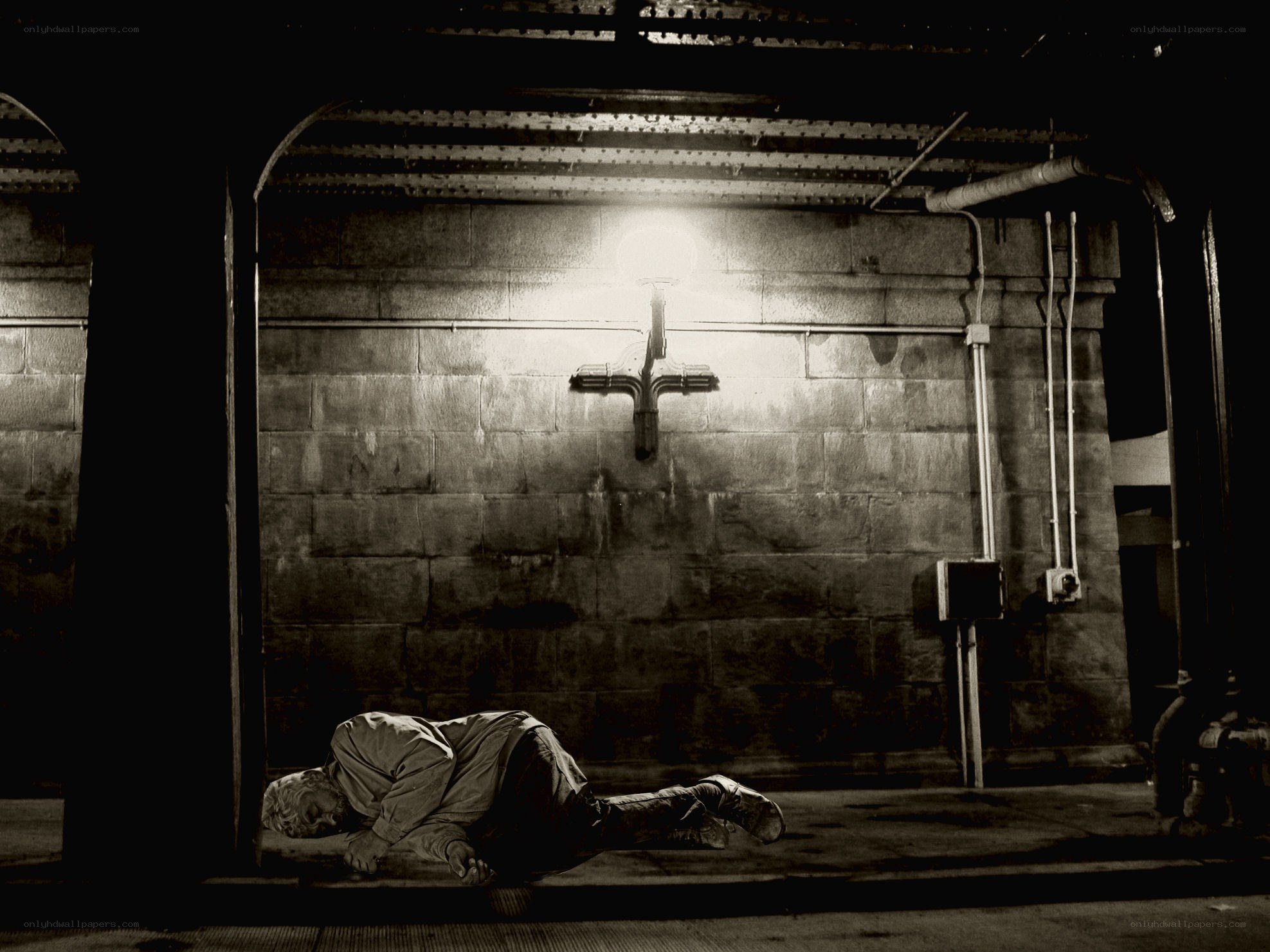 Homeless person sleeping under a bridge