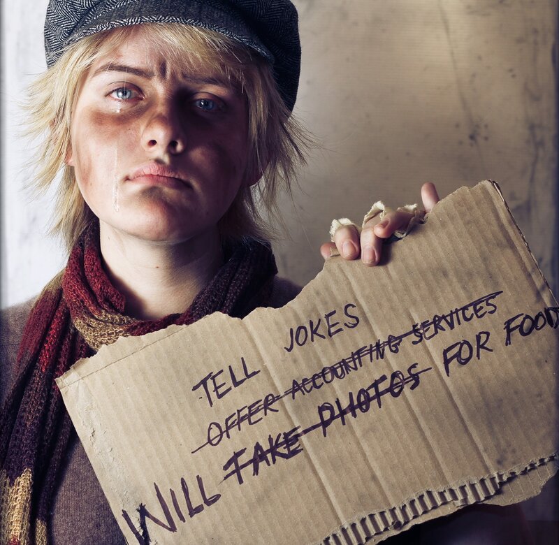 homeless person with cardboard sign