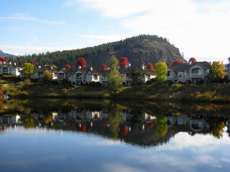 Homes by a lake with mountain view