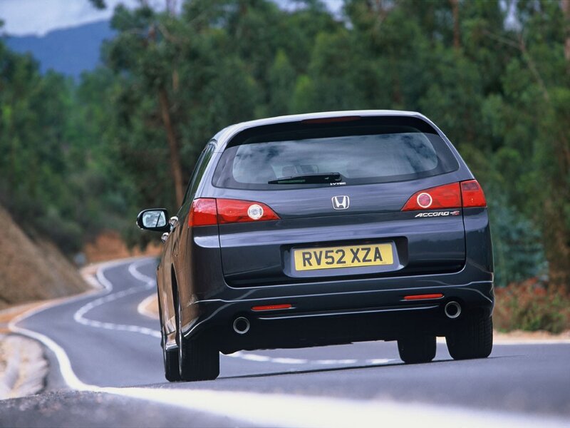 Honda Accord driving on a road