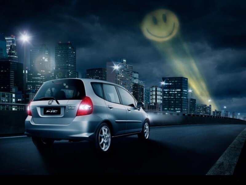 Honda Fit at night with smiley moon