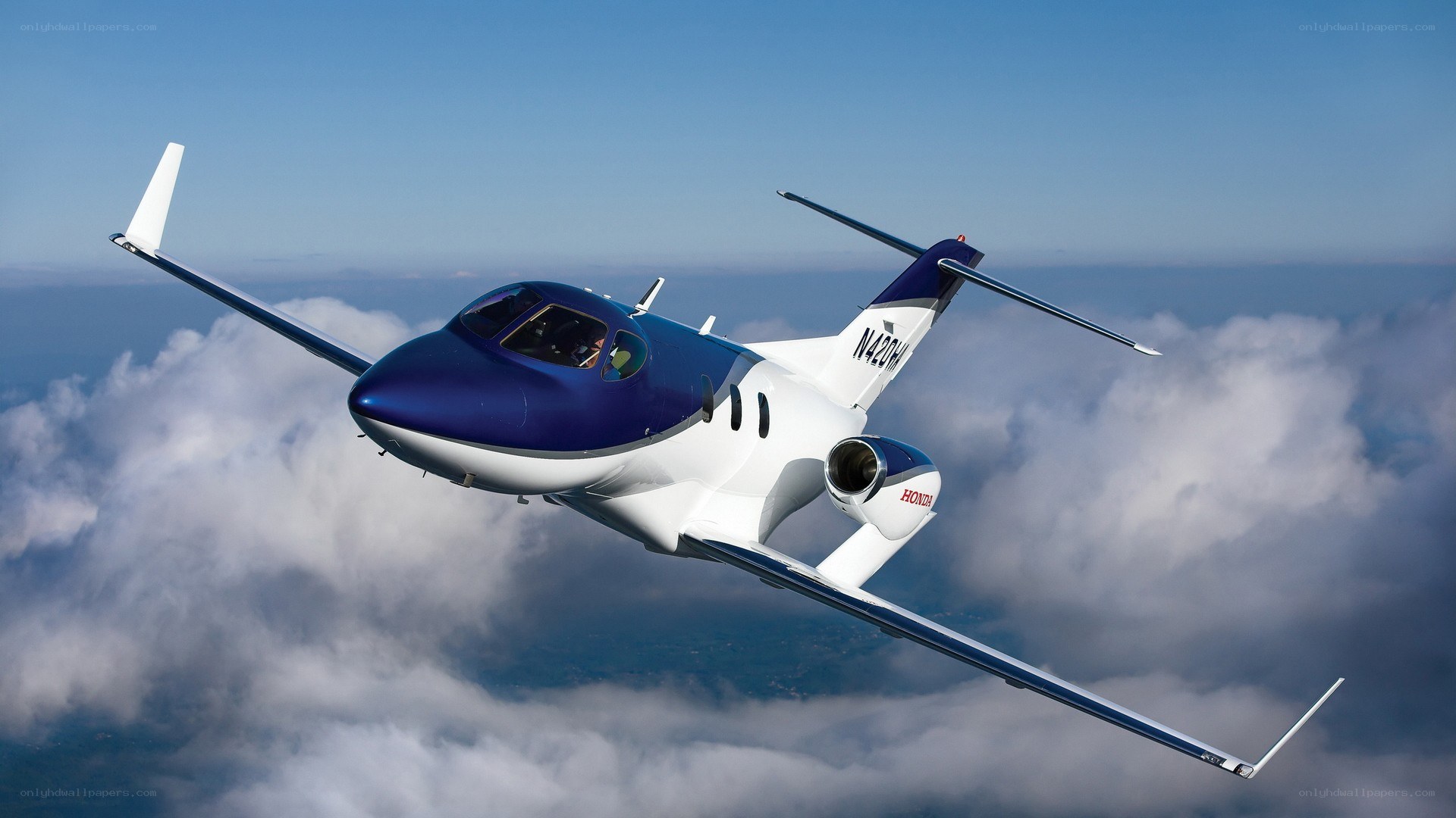 HondaJet in flight above clouds
