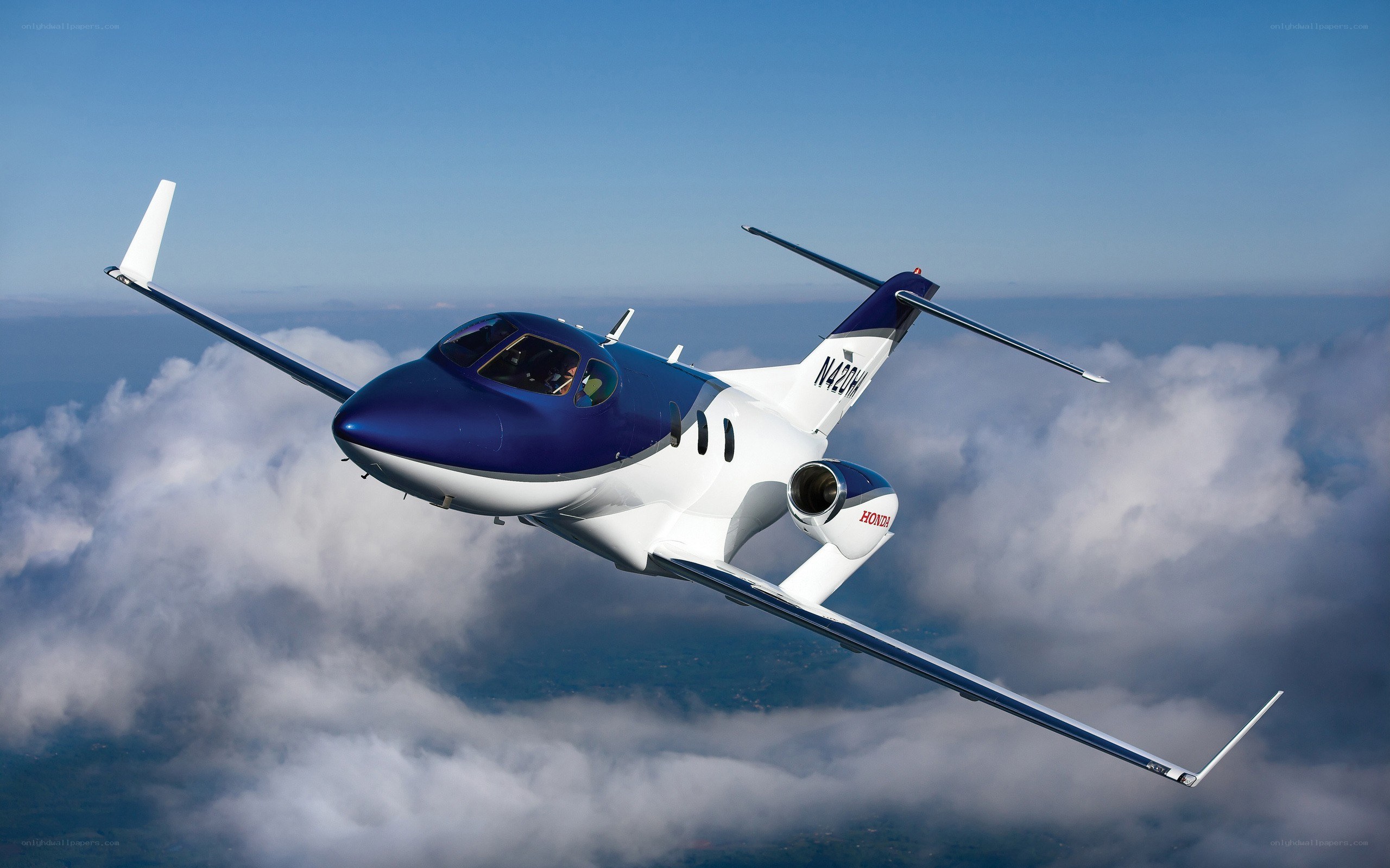 HondaJet in flight above clouds
