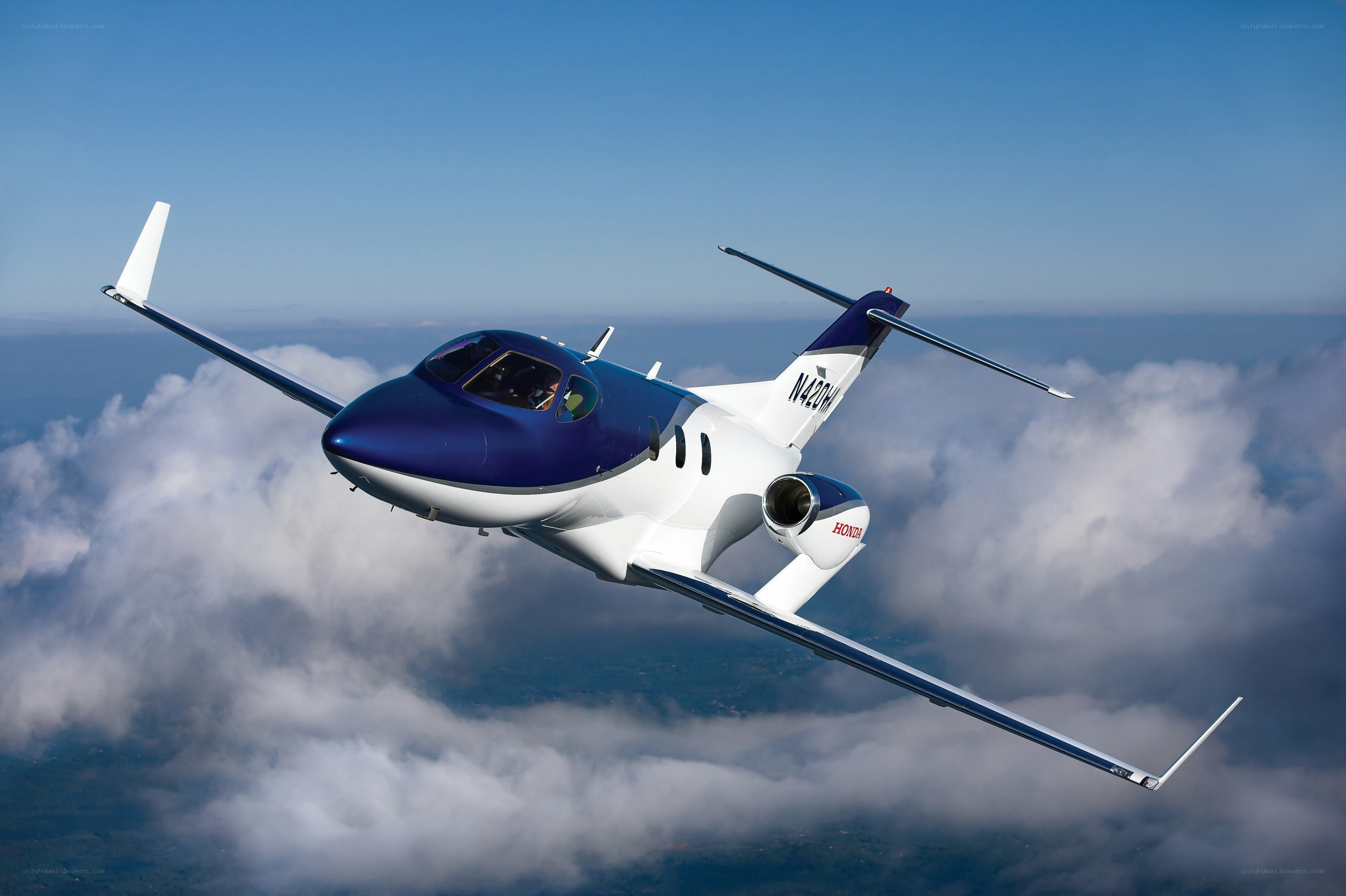 HondaJet in flight above clouds