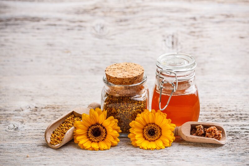 honey and bee pollen on wood