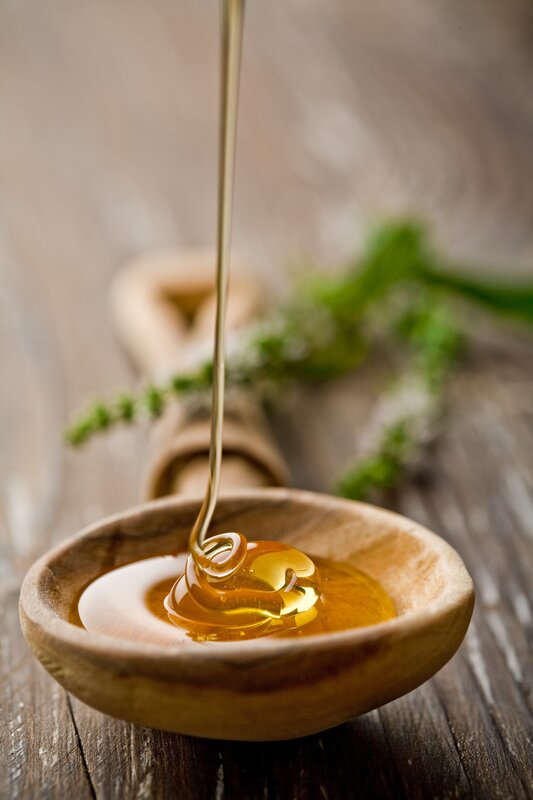 honey being poured into a bowl