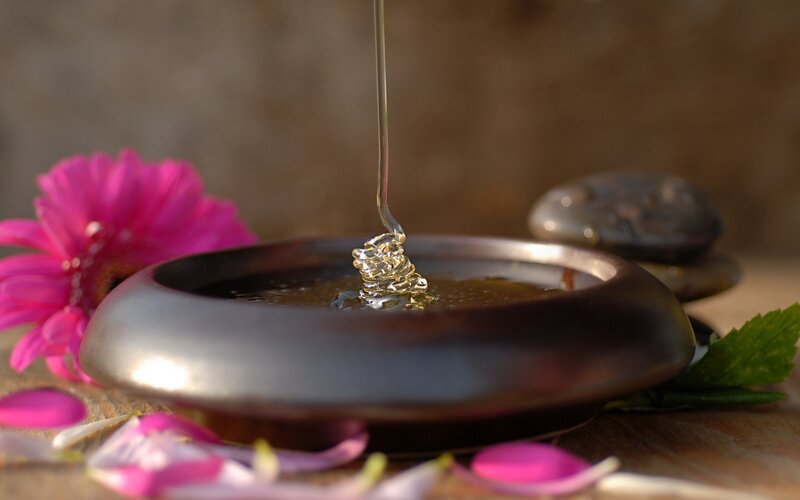 honey being poured into a bowl