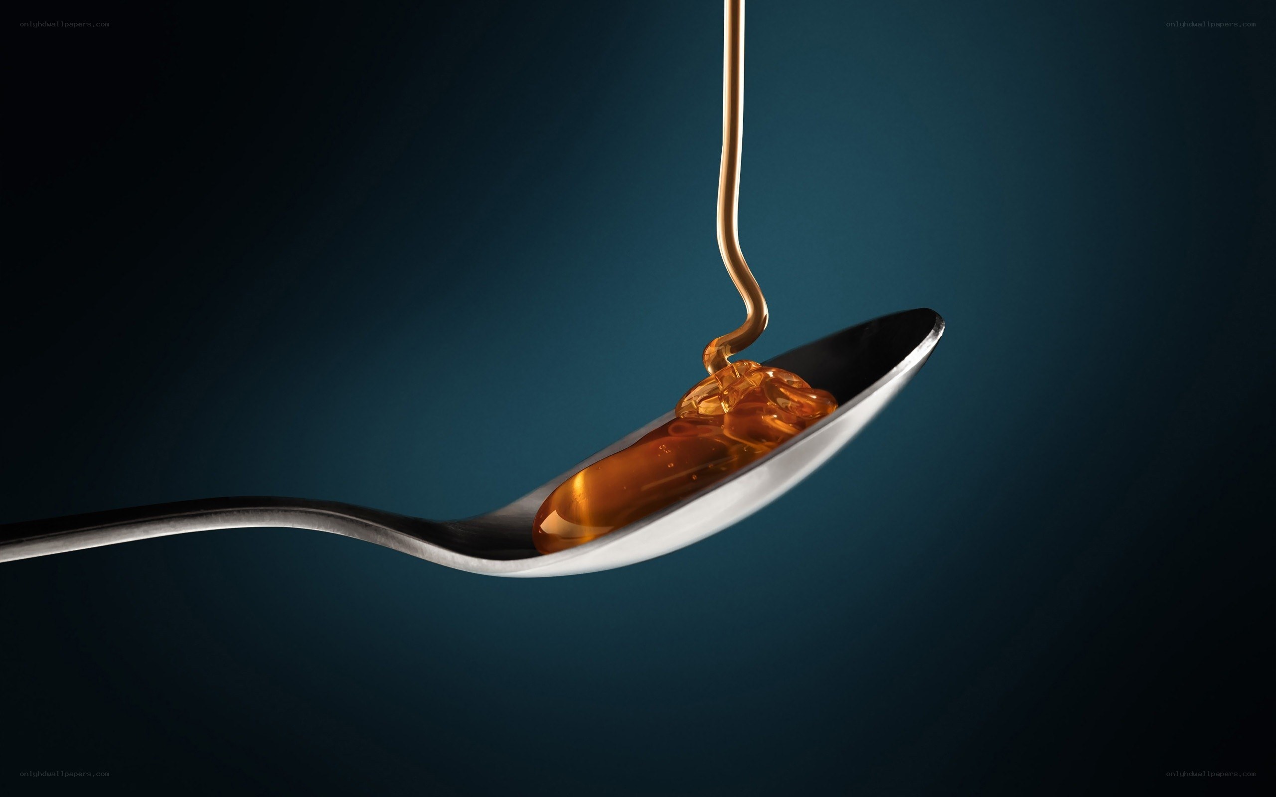 honey dripping on a spoon