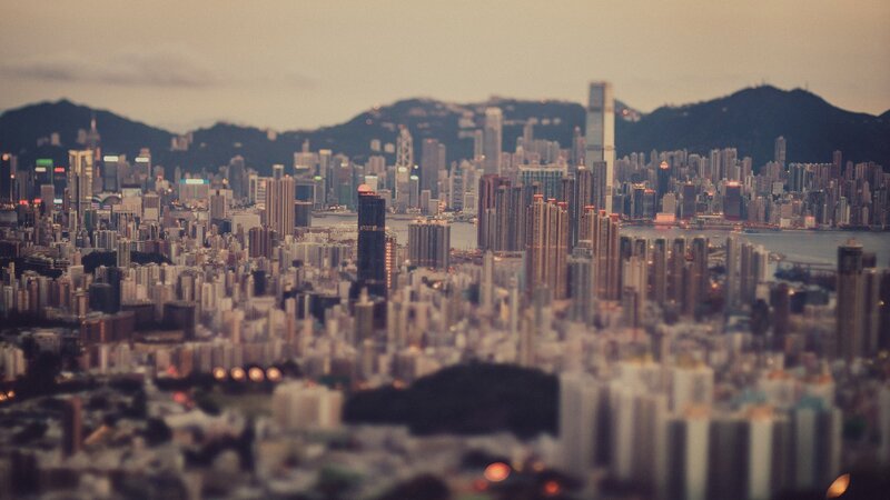 Hong Kong Skyline — Gray, Dramatic, Sunset, Photograph, Skyscrapers, Mountains